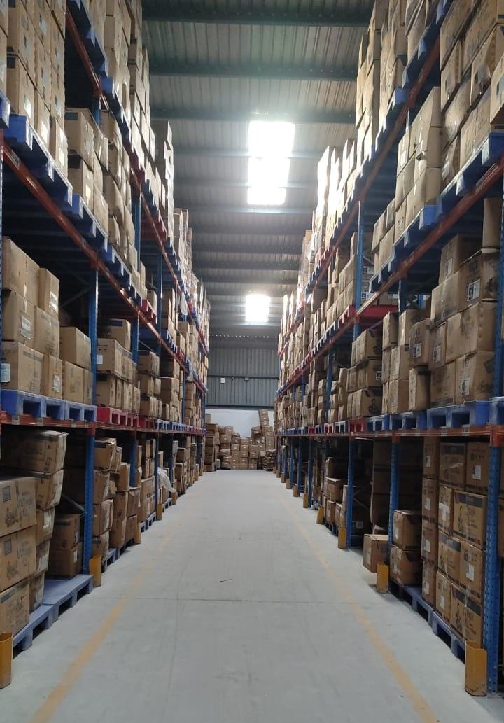 Long racked aisle stocked with cartons