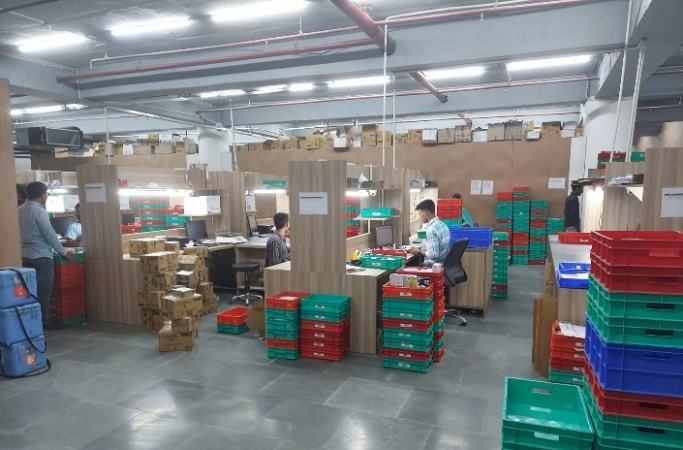 Packing area with crates and staff at work